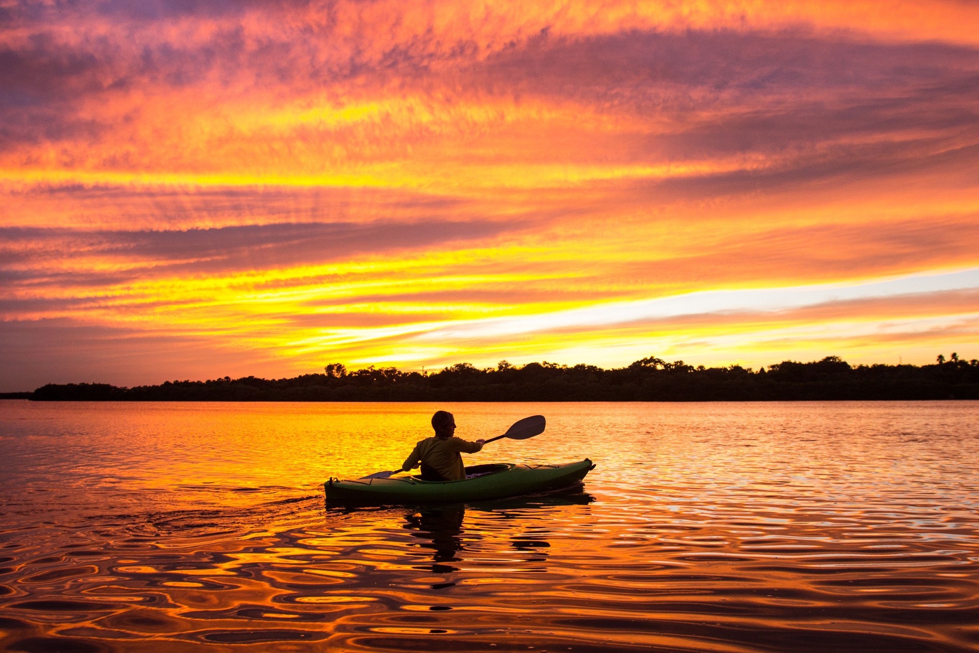 Woman Kayaking at Sunset